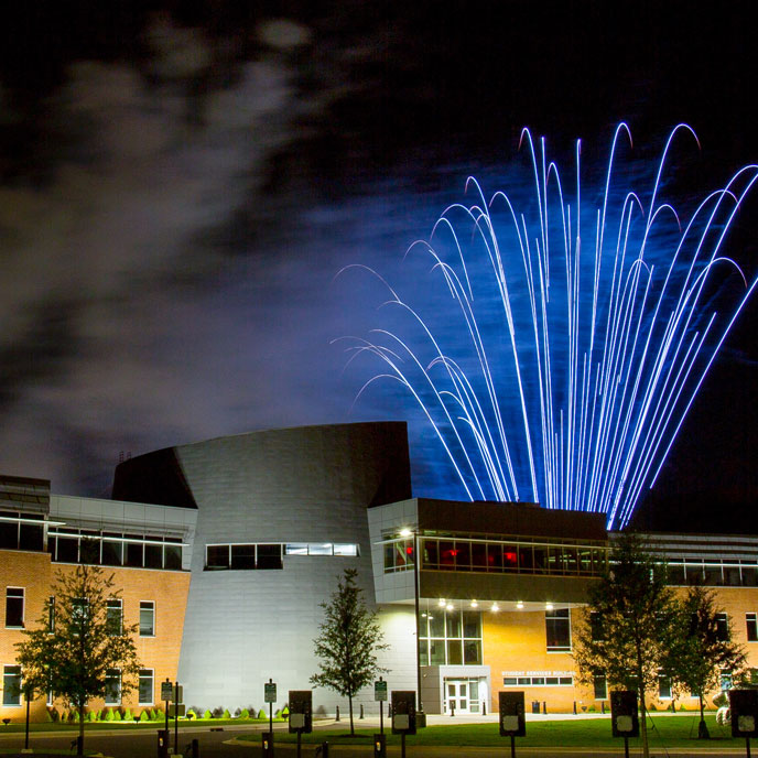 huge blue fireworks in the sky over the Student Services Building at UAH