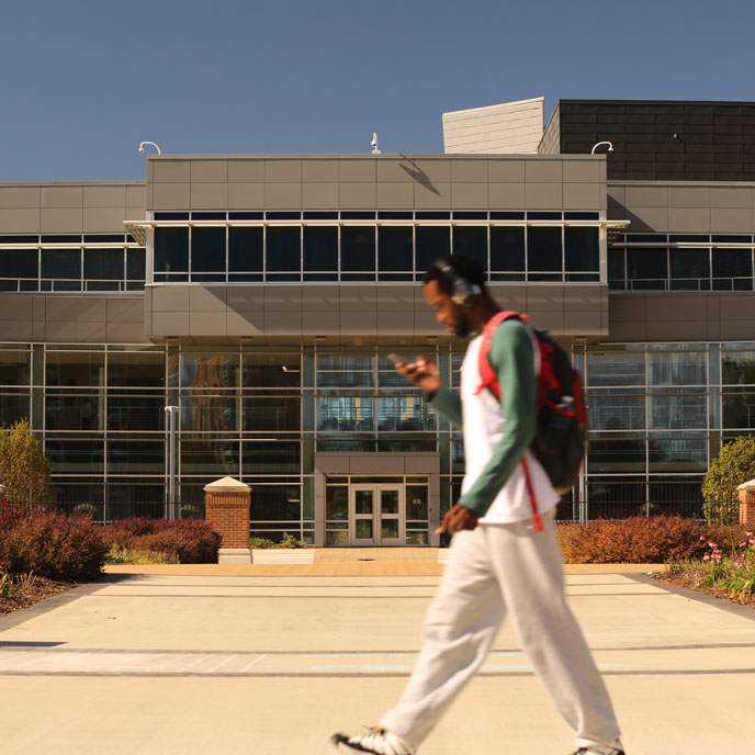 student walking on uah campus