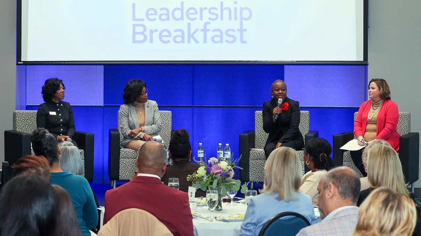 Several women speak on leadership at a leadership breakfast
