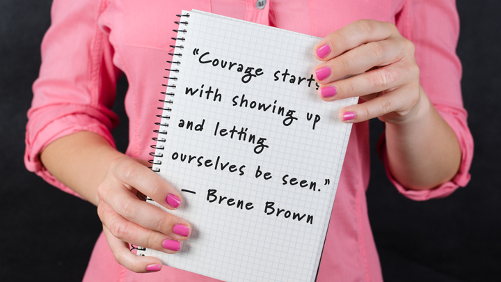 woman holding a sign with an inspirational quote