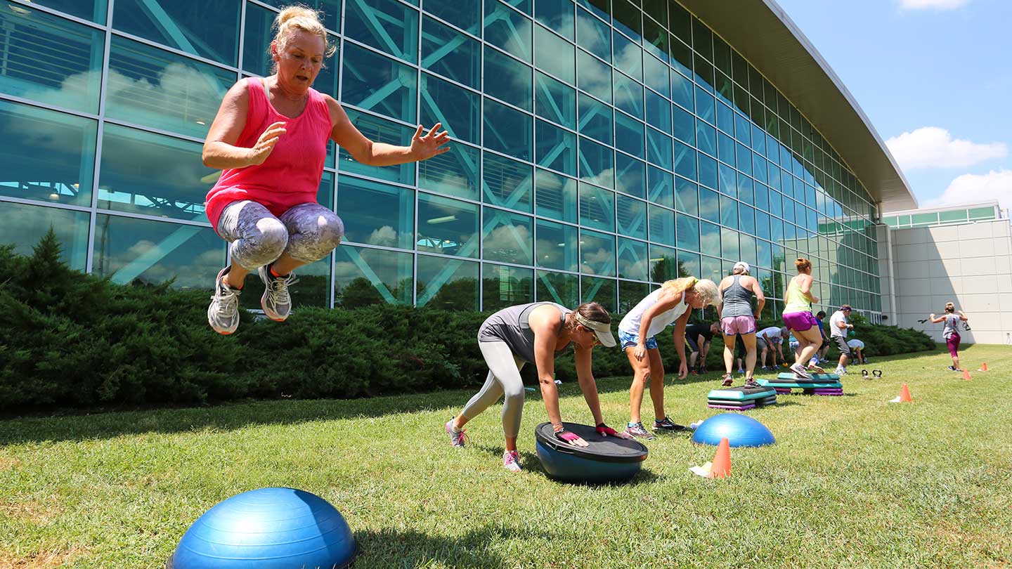 students group exercising outside.