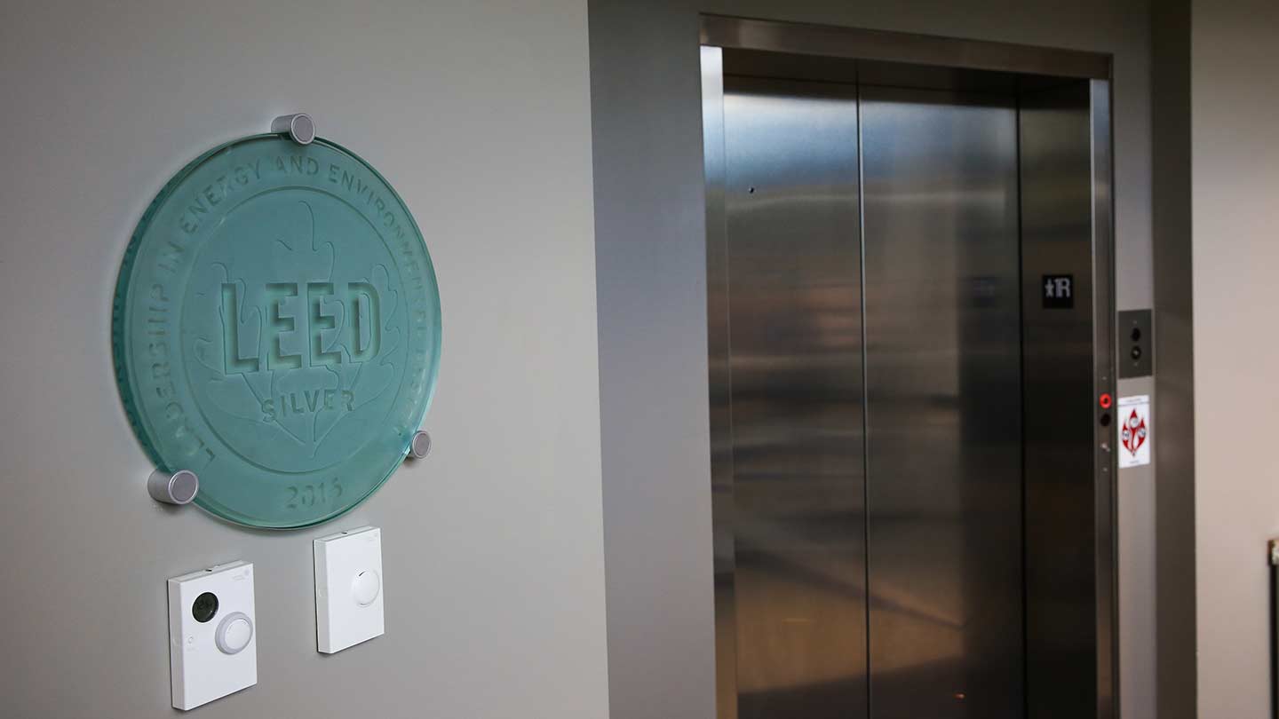 LEED logo on wall next to a closed elevator.