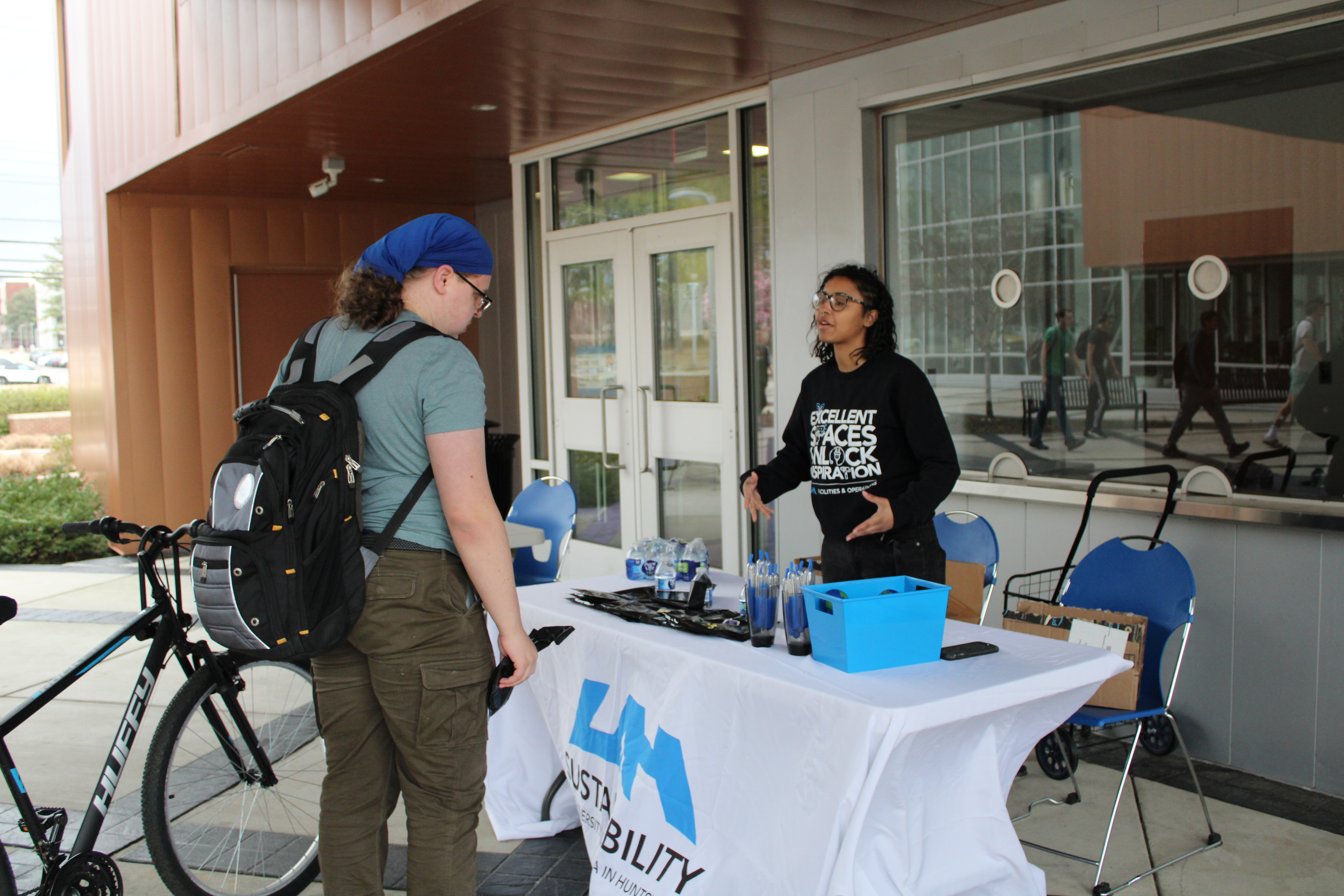 A student visits the UAH sustainability information table