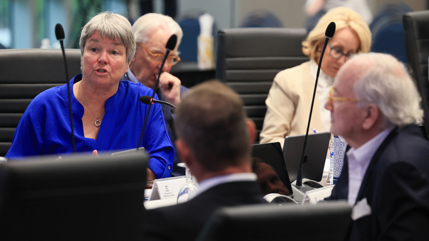 A woman expresses an opinion about a topic at a University of Alabama in Huntsville board of trustees meeting.