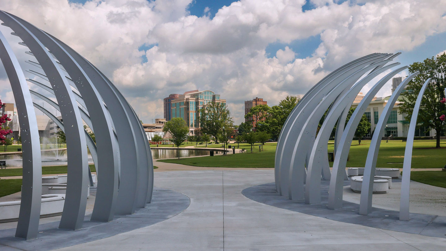a modern steel sculpture overlooking Big Spring Park pond in downtown Huntsville, Alabama.