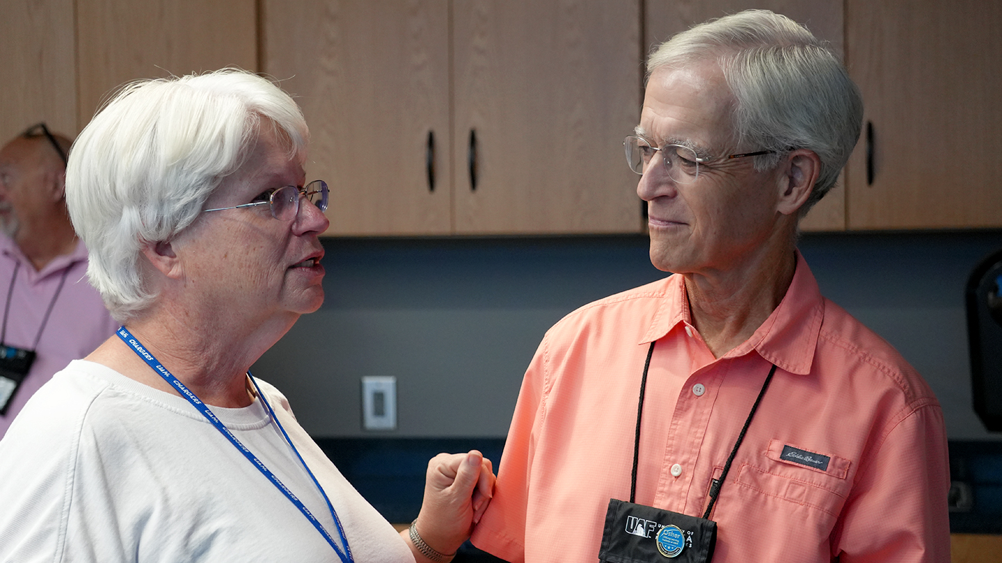 Janet Reville, OLLI’s 2022 Volunteer of the Year, congratulates Steve Stewart, the 2024 Volunteer of the Year