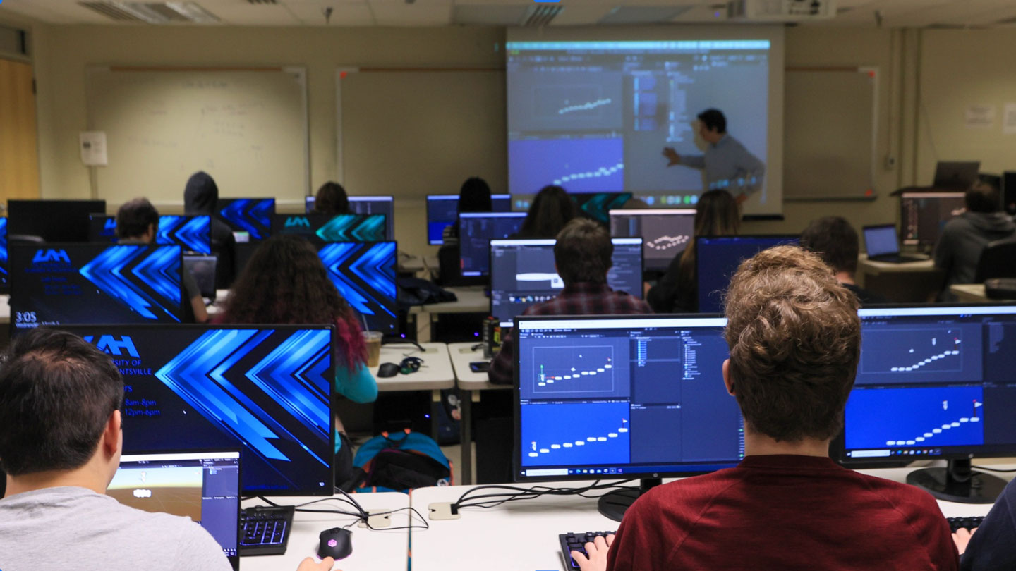 Graduate students study data science a computer lab in the College of Business.