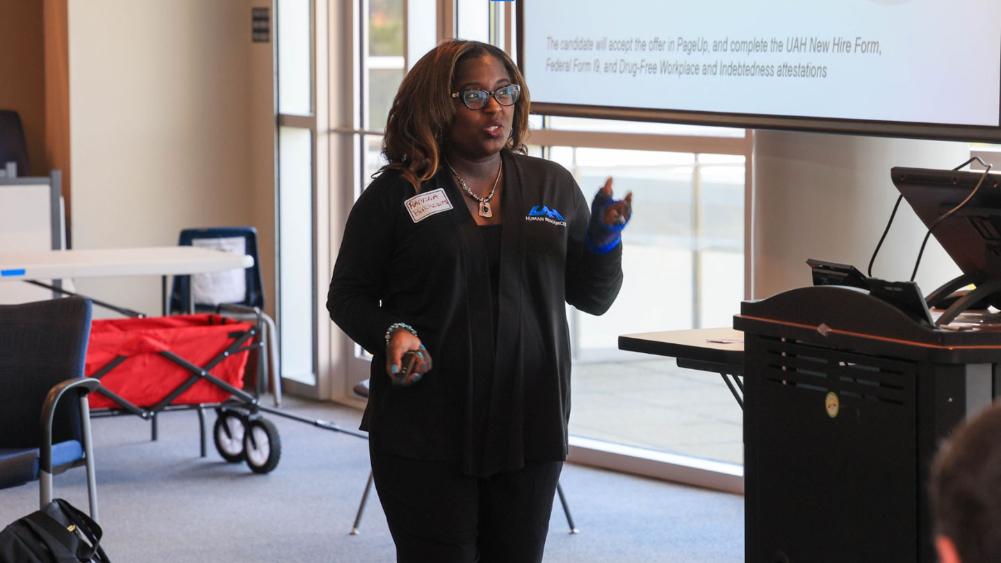 A human resources professional provides training for a new software platform