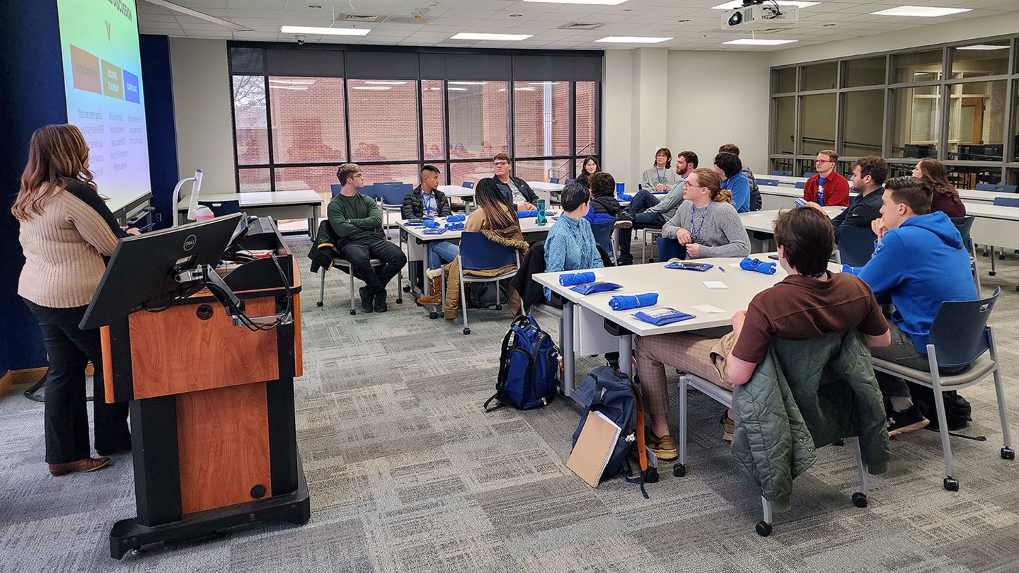 A UAH staff member asks a question to a group of student workshop attendees.