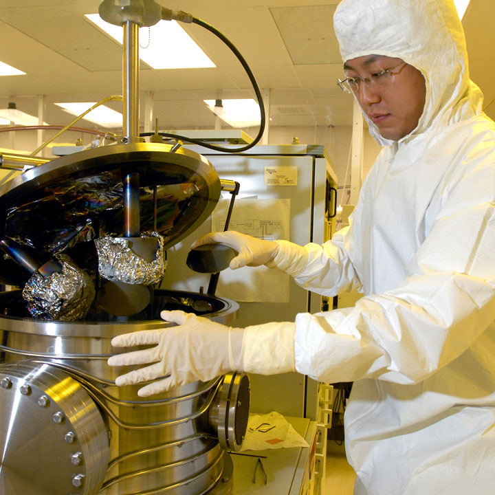 A graduate student conducts research in a sterilized clean room