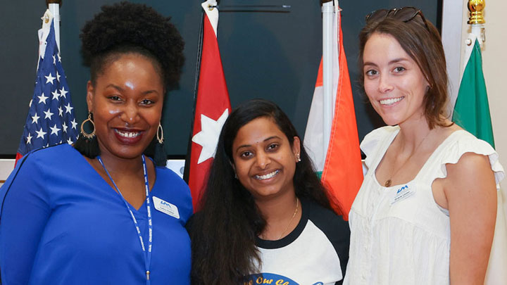 International U A H students smile in front of a display of international flags