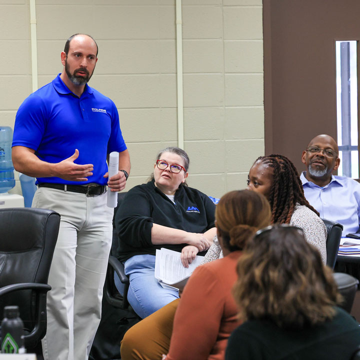A group of non-degree students participate in a discussion with a guest speaker from Polaris Manufacturing.