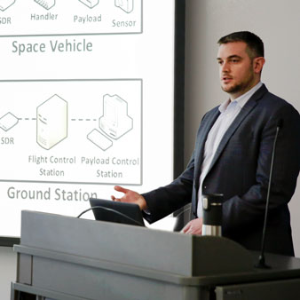 A U A H graduate student performs a 3-minute thesis demonstration.