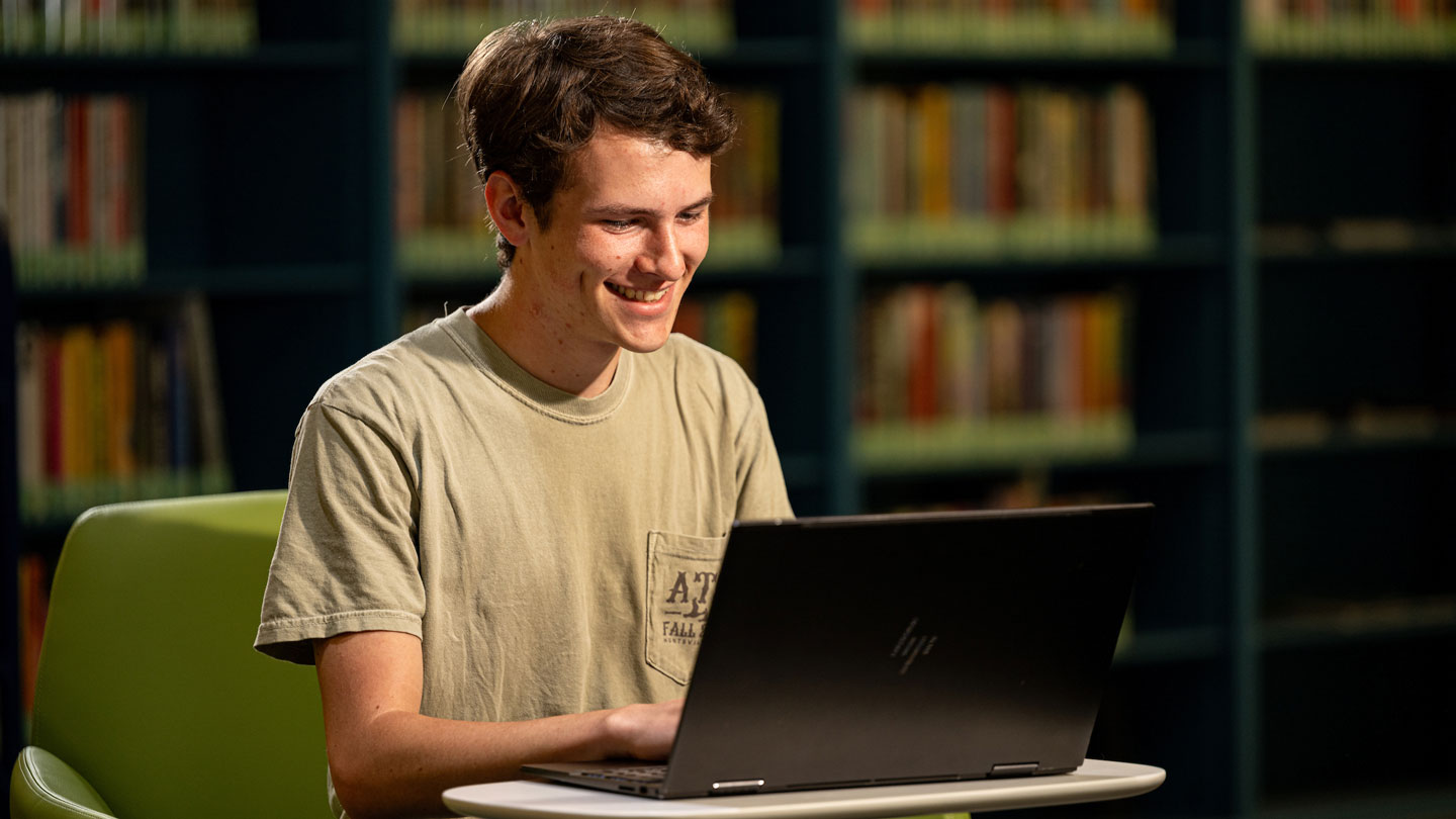A prospective student checks his computer for good news.