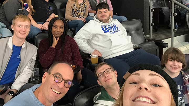 Group of people setting in stadium seating.