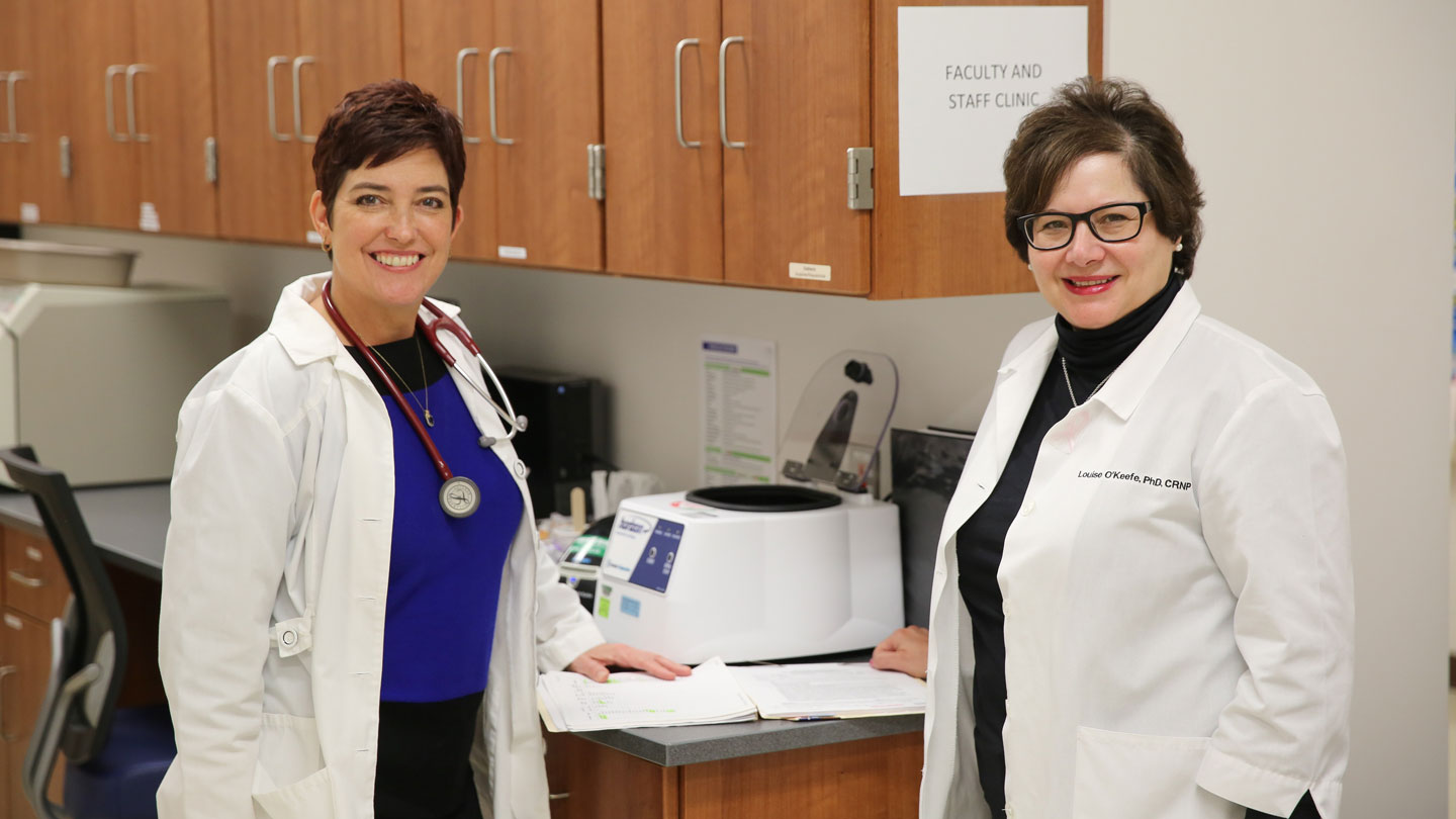 Connie Abbott and Louise O'Keefe posing together at the UAH clinic office.