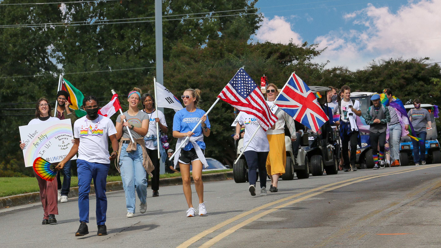 students and faculty march in the 2021 LGBTQ+ pride parade at UAH