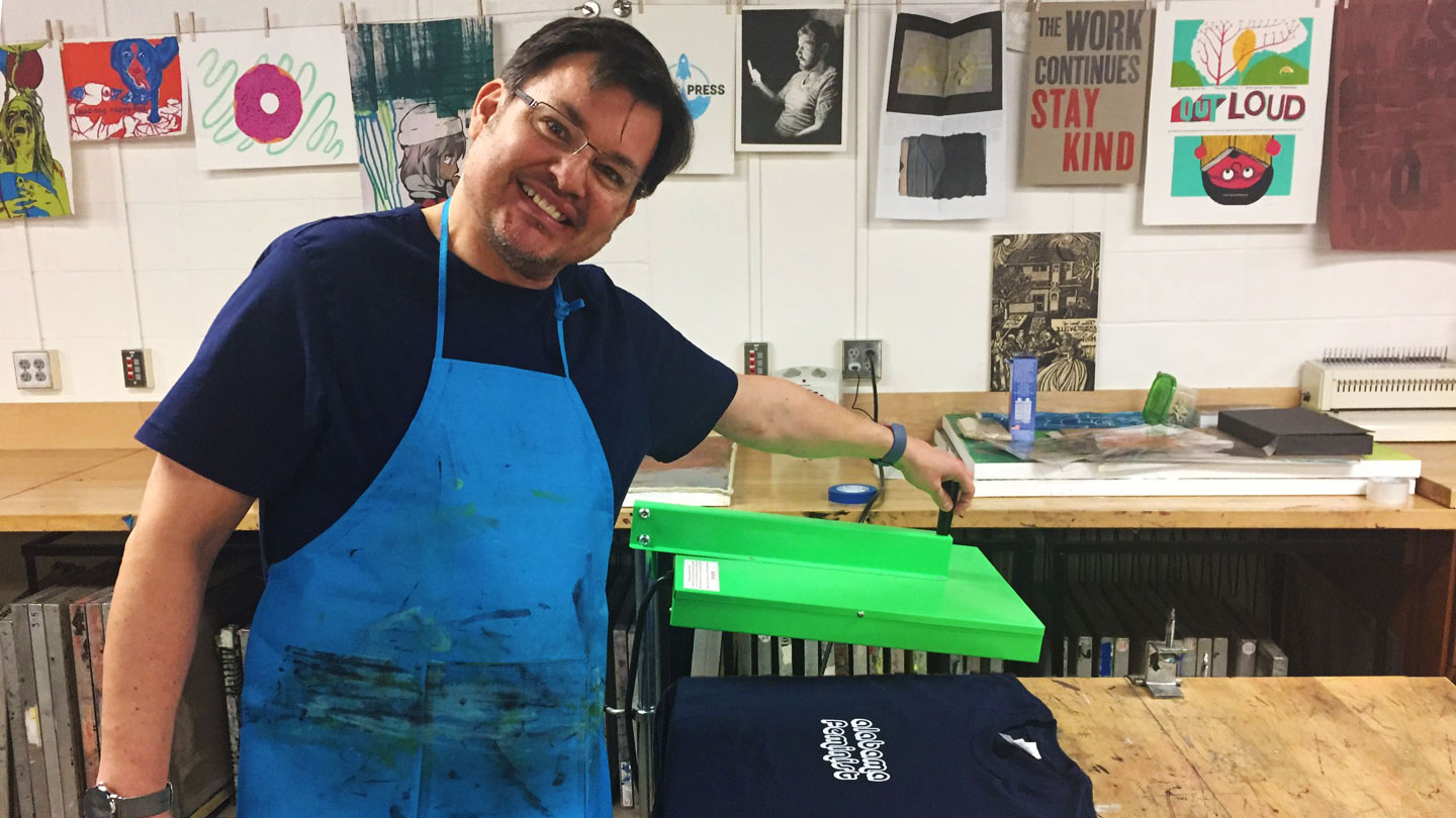 a UAH professor screen printing a feminist themed t shirt