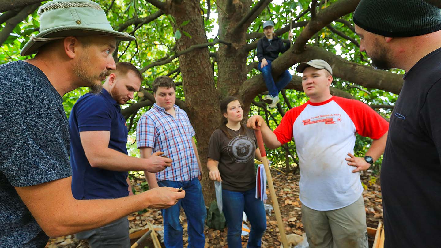 Ben Hoksbergen leads some history students on an archaeology dig around Roberts Hall.