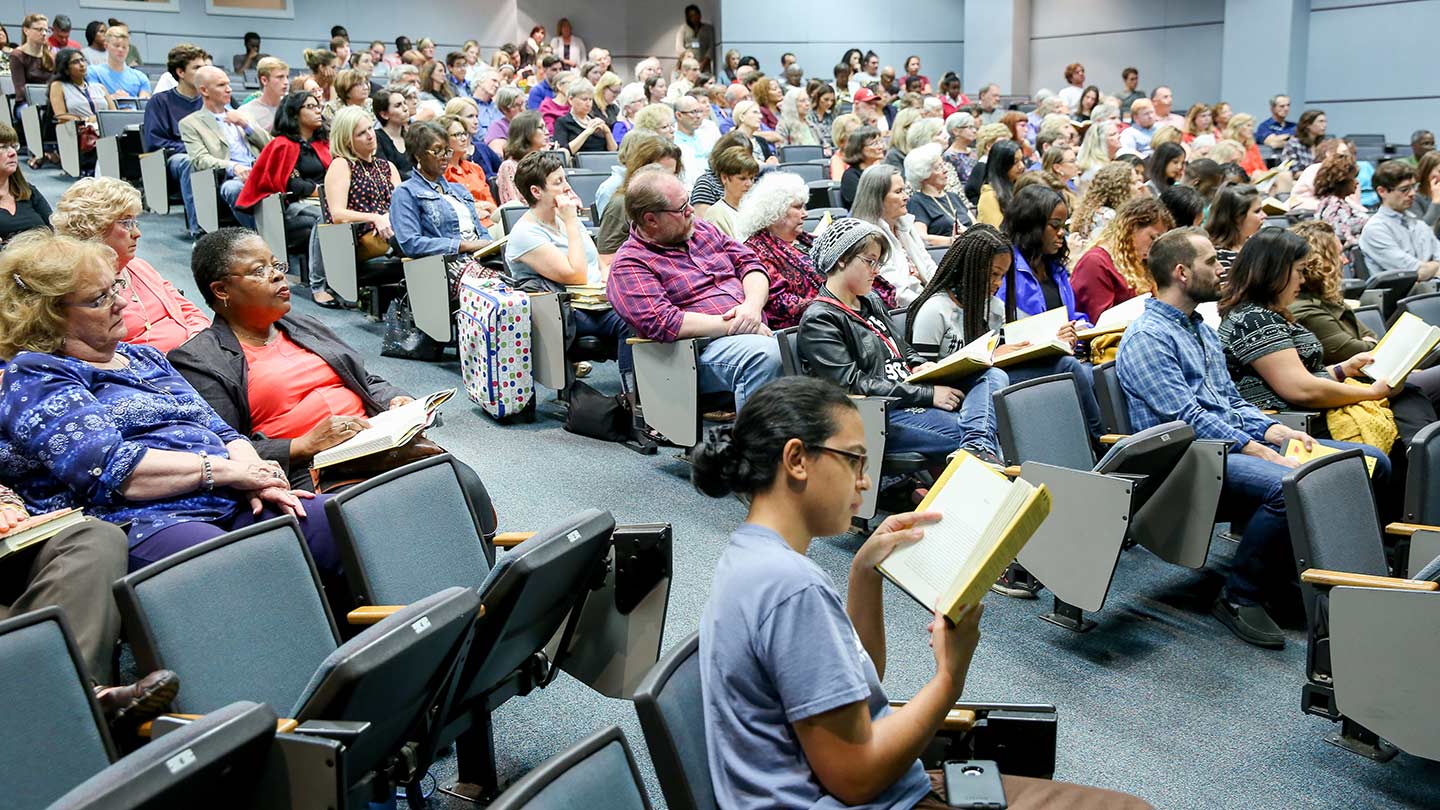 students read in a lecture hall