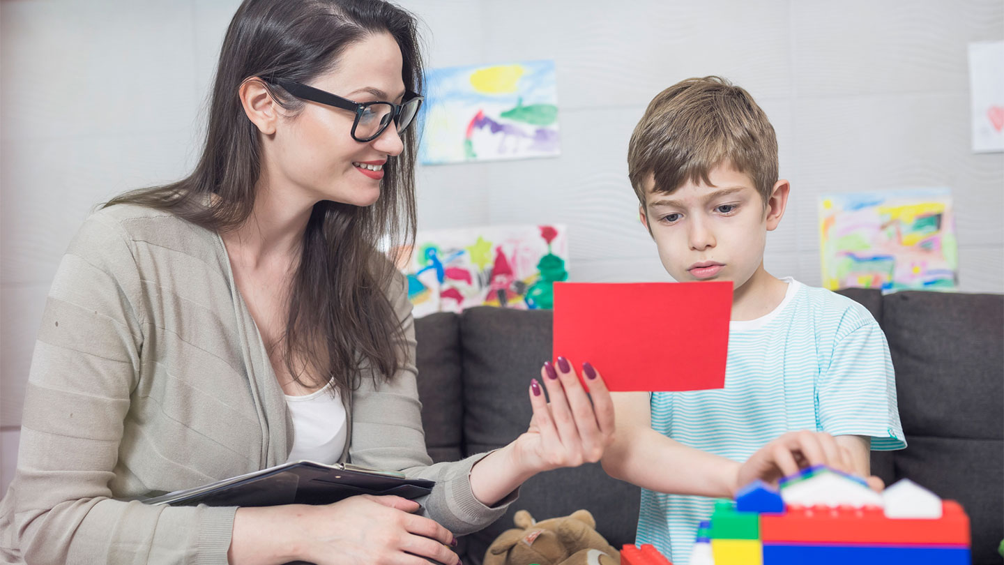 psychology student shows cards to a child