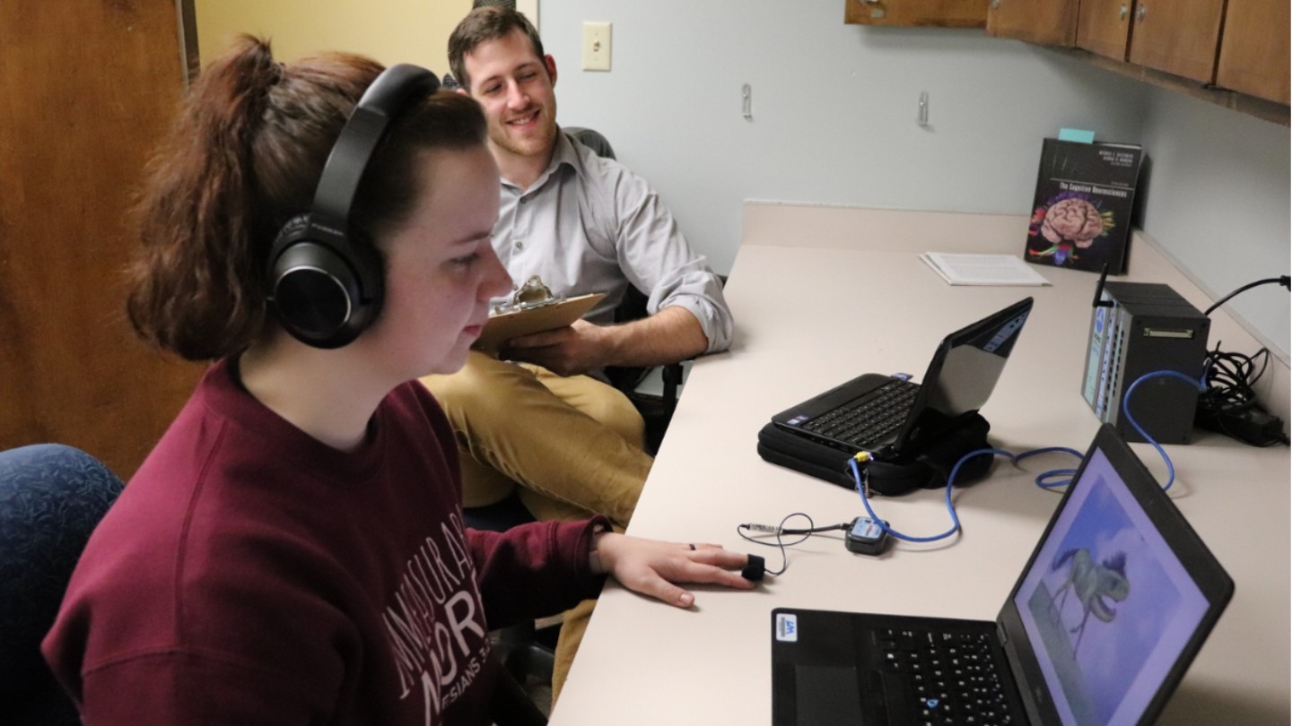 Two Students in a Psychology Lab looking at a computer