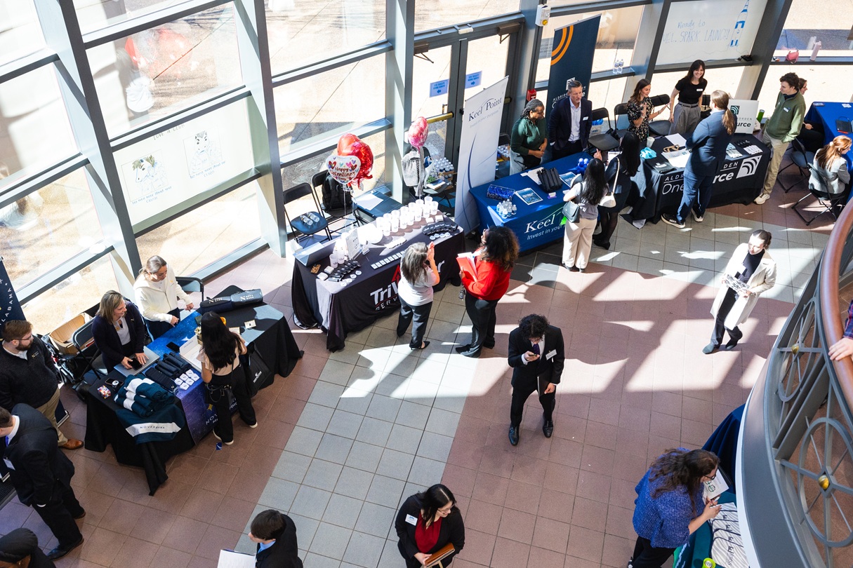 Professionals engaging with students at the college of business career fair