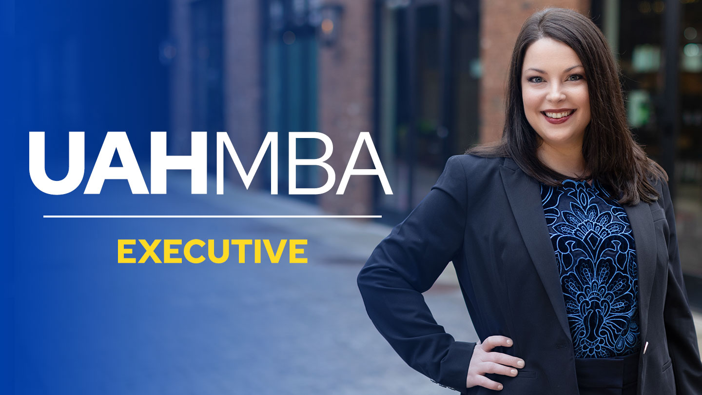 A smiling U A H executive M B A student in business attire. Text reads U A H Executive M B A student in business attire. Text reads U A H M B A Executive