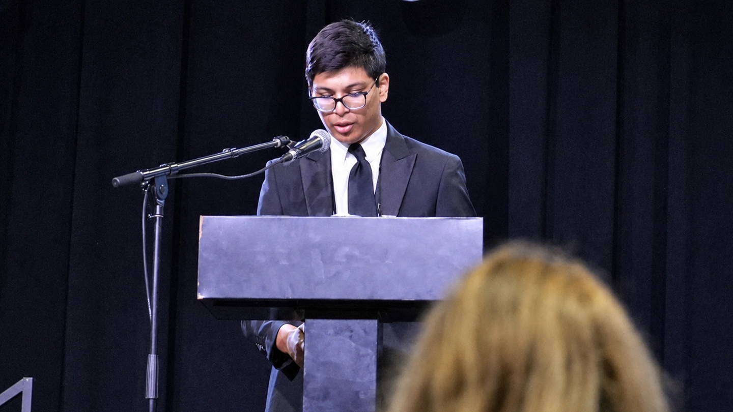 student at podium speaking