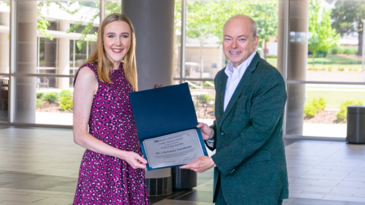Dr. Christian Smart presents Christina Tarsitano award on behalf of The Greater Alabama Chapter of International Cost Estimating and Analysis Association (ICEAA).