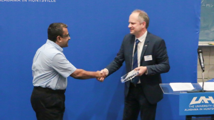 Dr. Tathagata Mukherjee accepts Faculty Excellence in Research award.