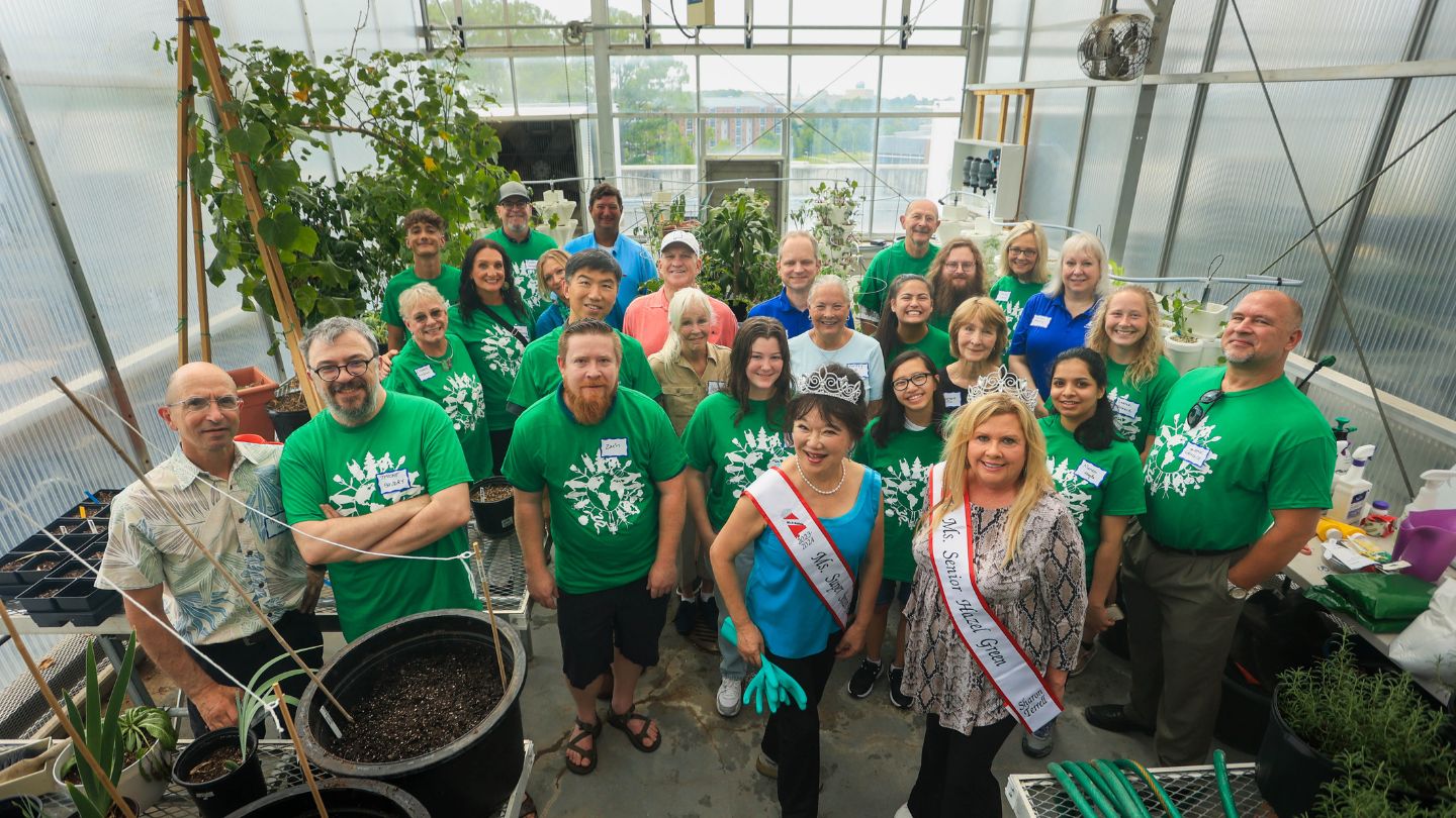 Dr. Kathy Chan (blue, front row), UAH President Dr. Karr (pink), College of Science faculty, staff and students.