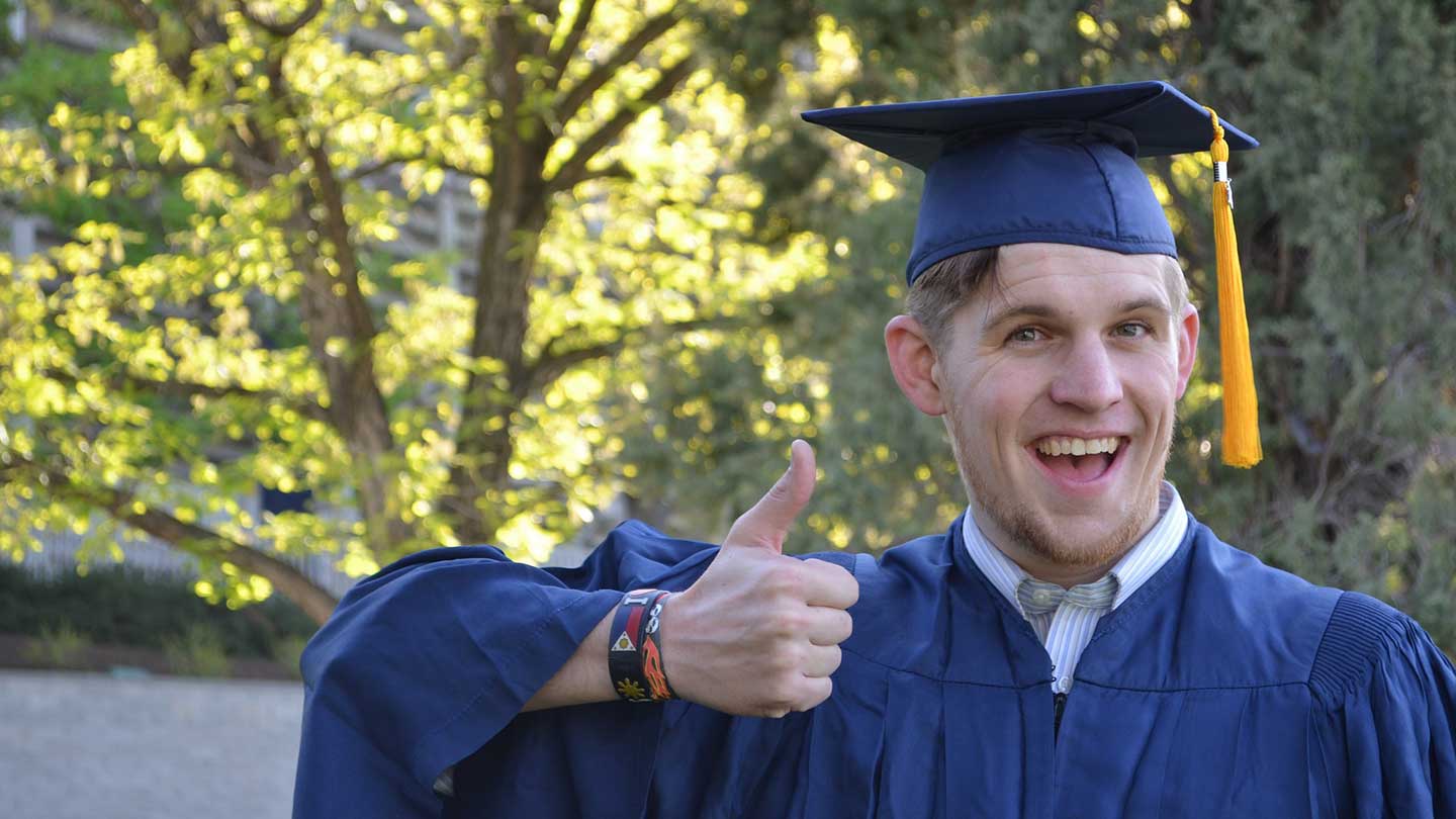 Chemistry graduate in cap & gown.