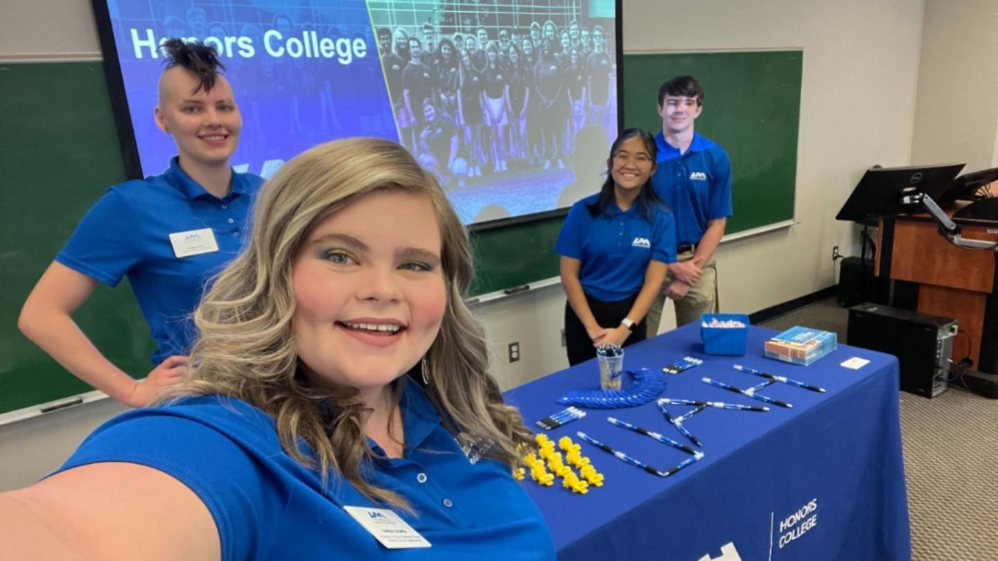 Honors ambassadors posing for a selfie at an event
