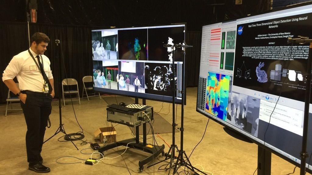 two large screens present data