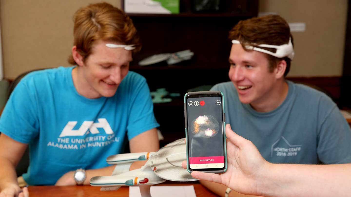 two people use their headset scanners to record brain wave data