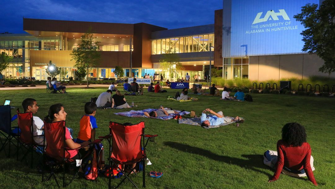 students relax in front of the charger union on the lawn