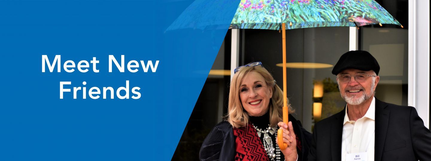 a man and woman share an umbrella with the text make new friends