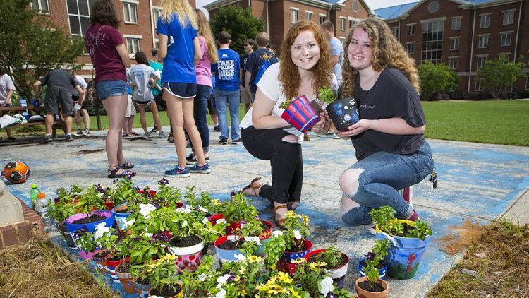 two women admire the plants they have grown