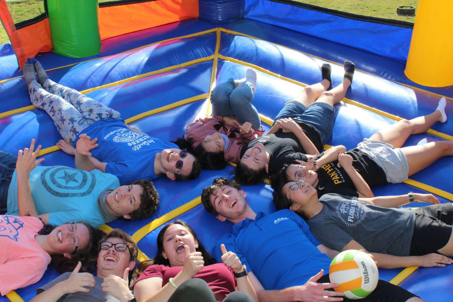 honors students rest on an inflatable together