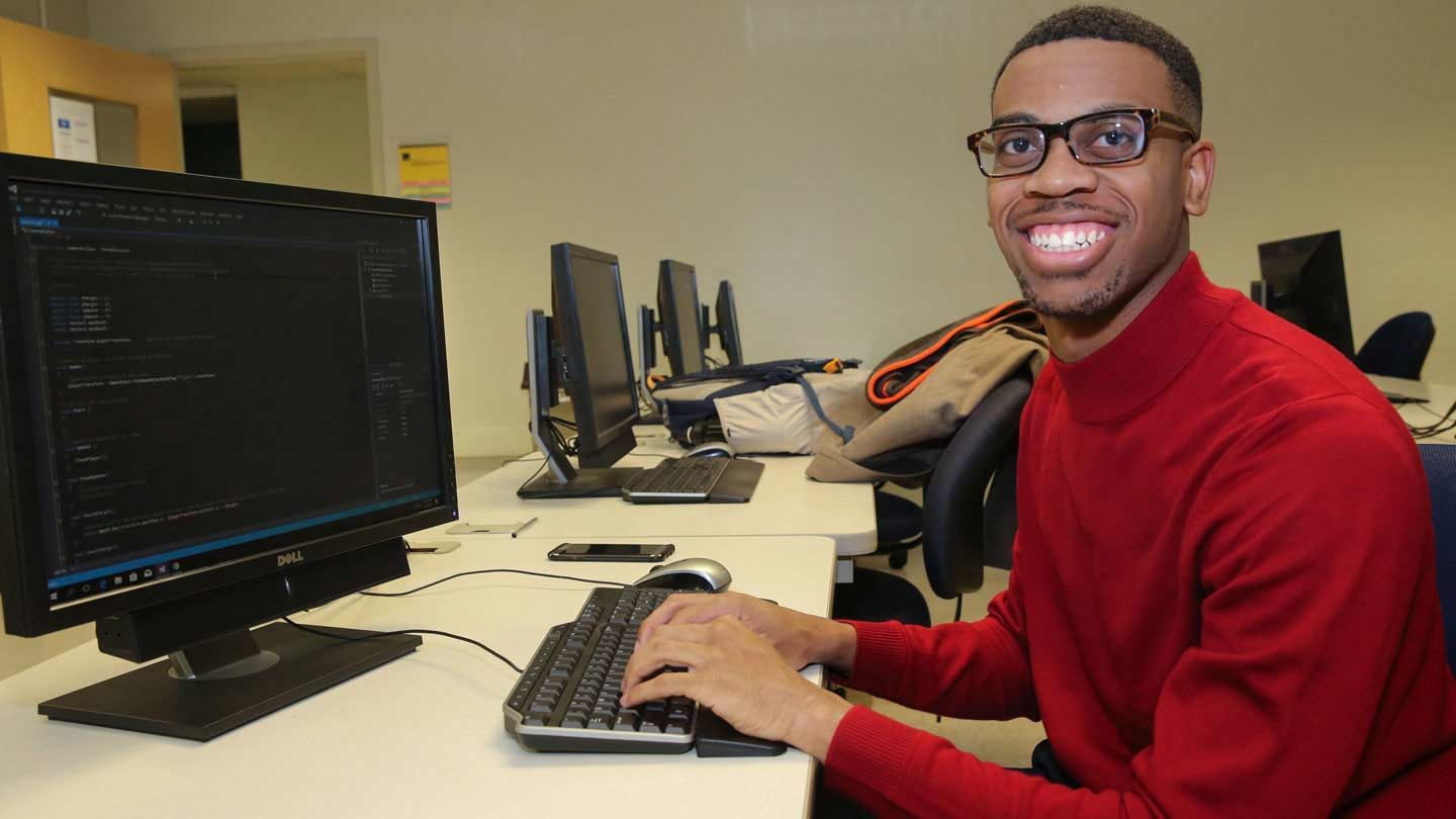 a man types at a computer