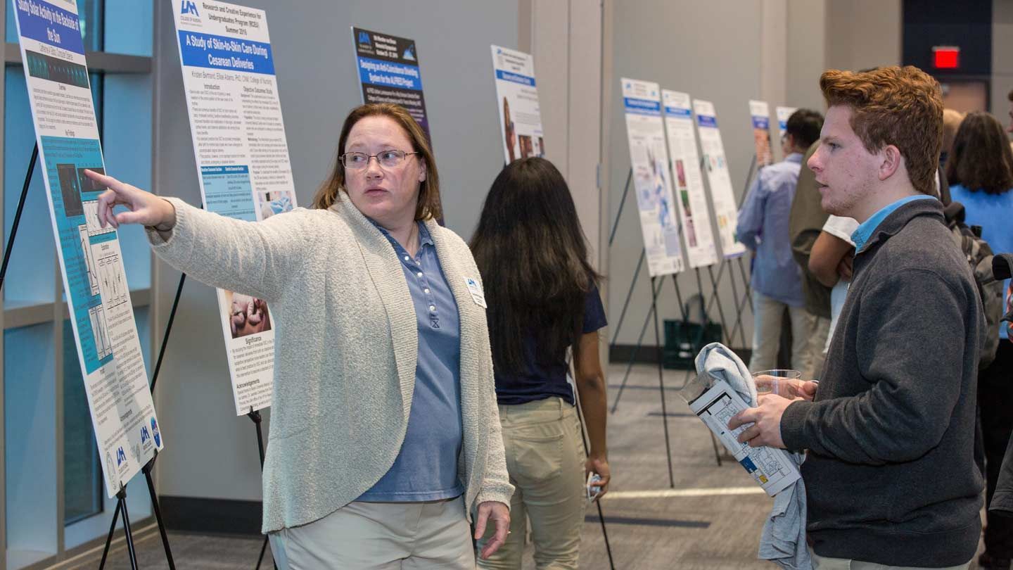 a woman uses a visual aid to explain something to a student