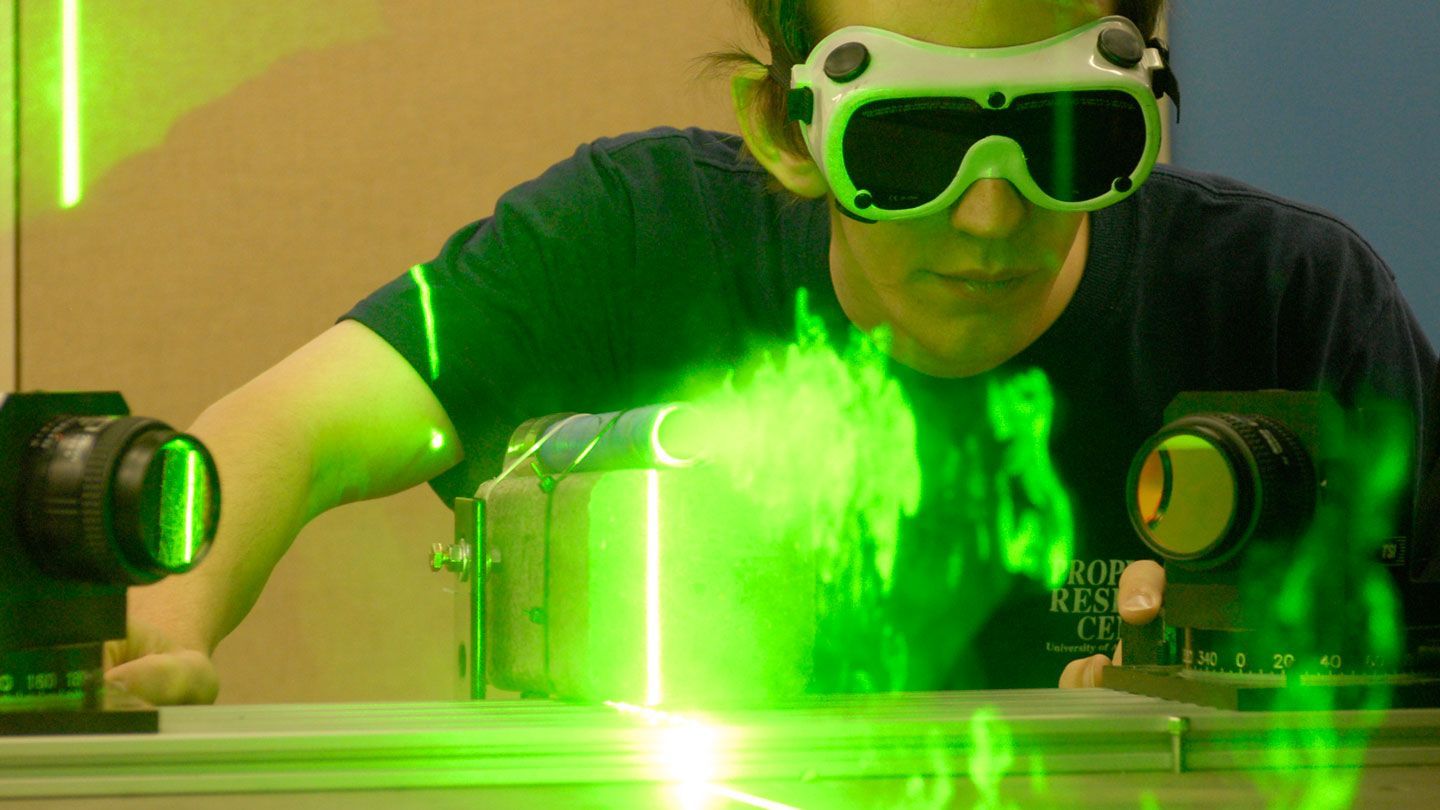 Researcher works on a green laser