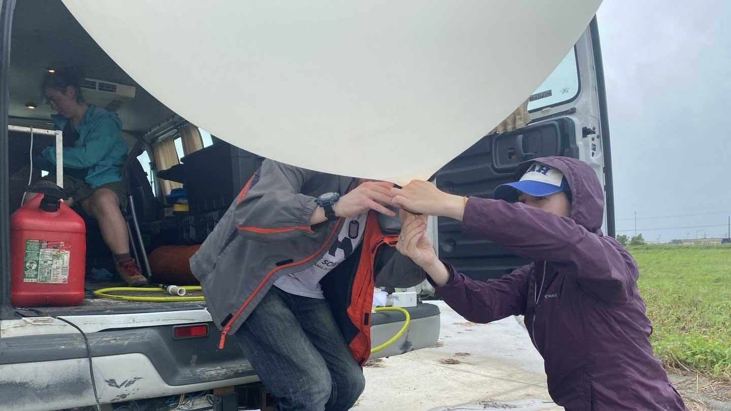 Students and researchers prepare weather balloon to launch ahead of Hurricane Ida.