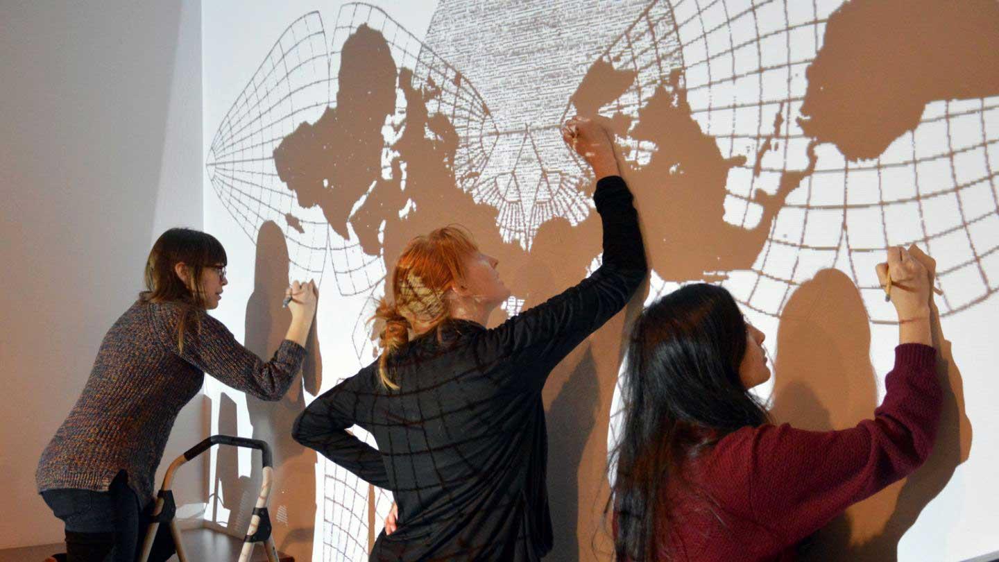 Earth System Science students create wall mural of the Earth.
