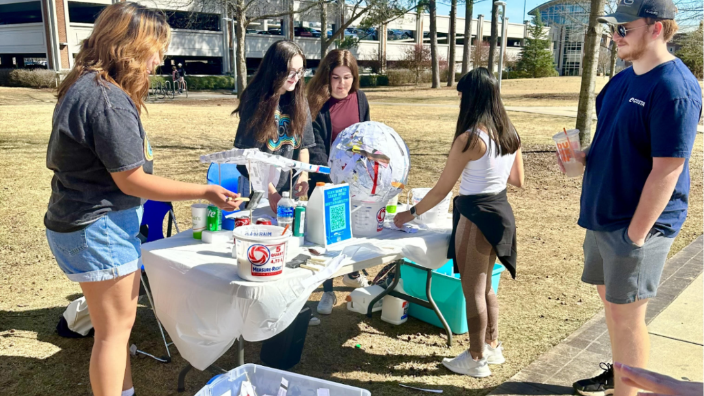Students Gather Around a Table for a Sustainability Event