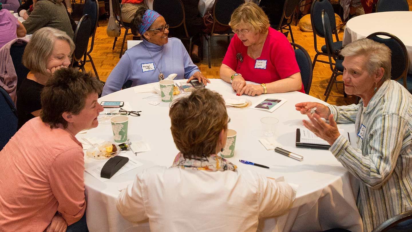 people have a conversation around a table
