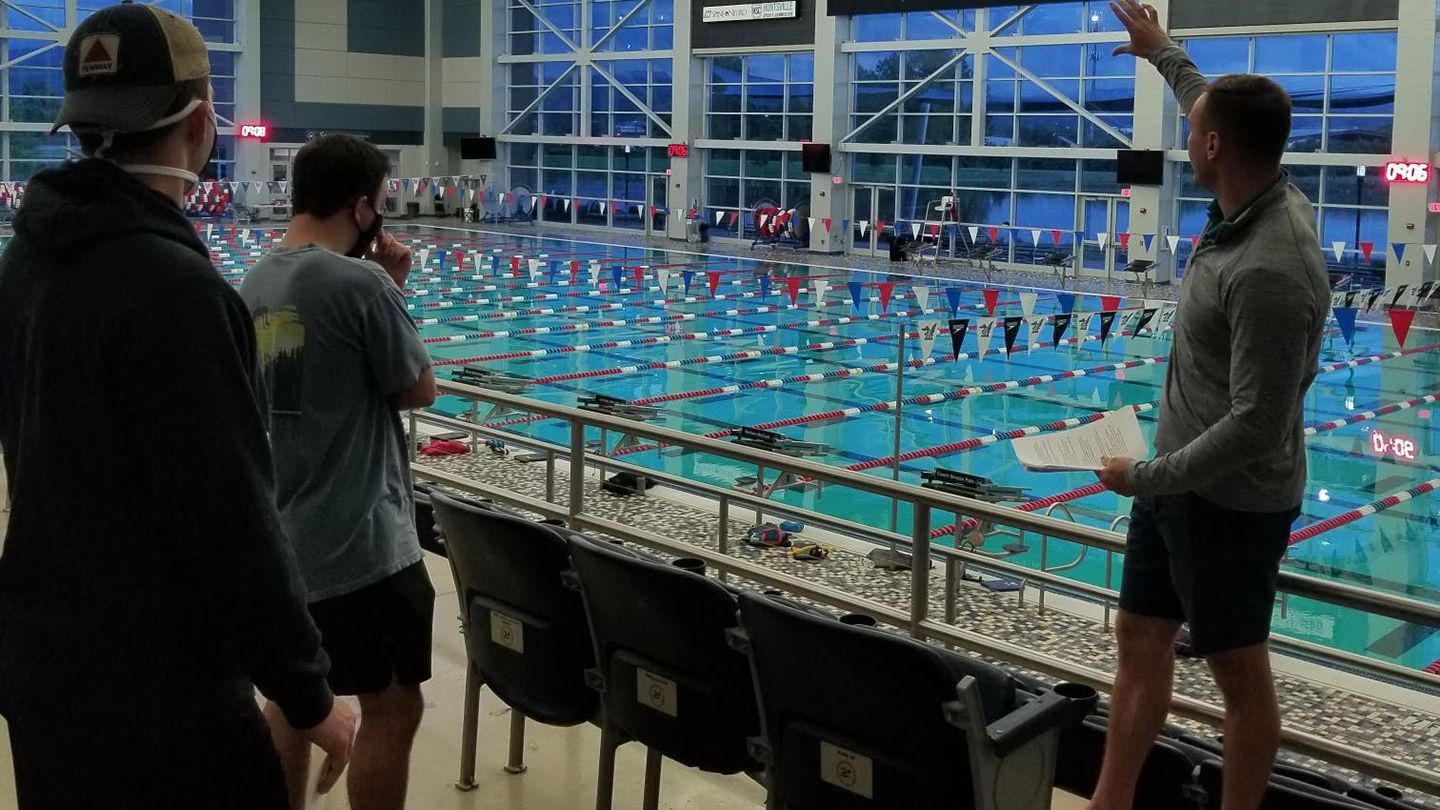 a tour is given of a large aquatic center including a large indoor pool