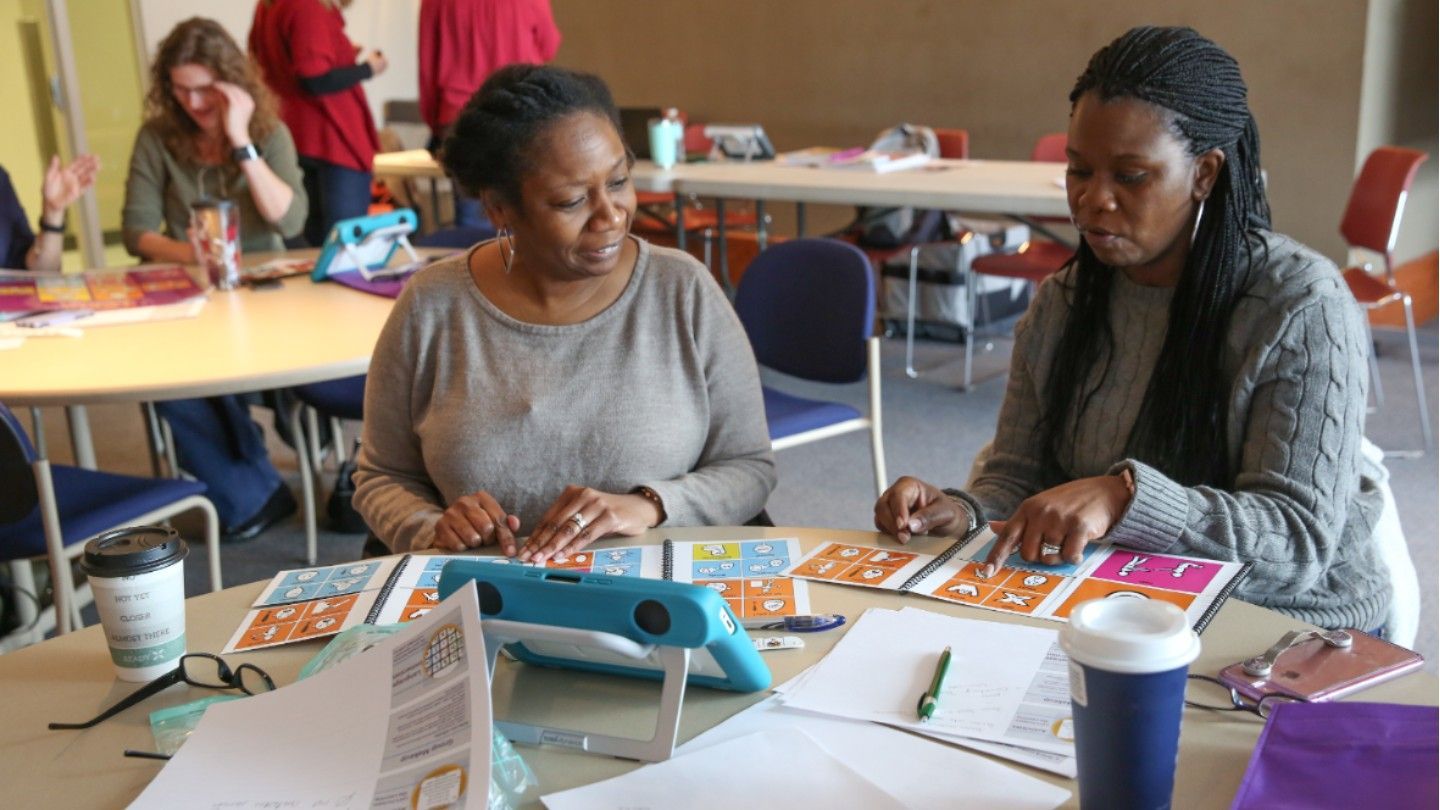 Two women attending an autism workshop