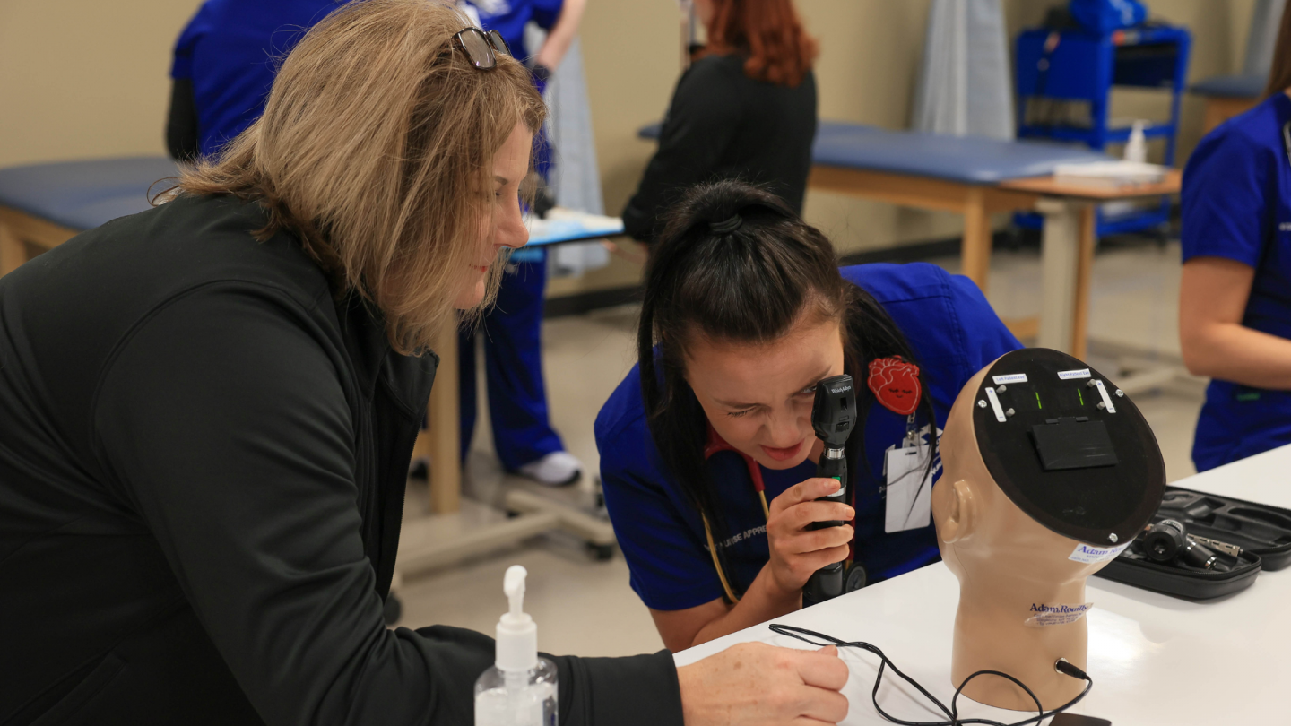 student nurse examines dummy